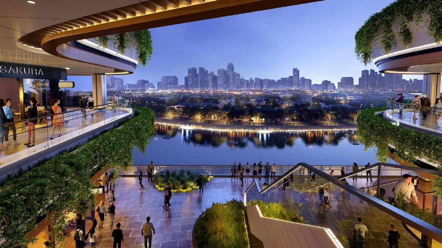 Evening view of a modern riverside shopping and dining area with vibrant city skyline in the background, featuring lush greenery and sleek architecture.