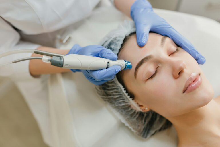 Close-up of a woman receiving a HydraFacial treatment at a professional skincare clinic.